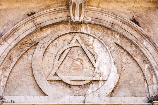 Conspiracy theory concept of Illuminati triangle and All Seeing Eye on an ancient temple