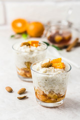 Overnight oats with tangerines and almonds. Selective focus, space for text.