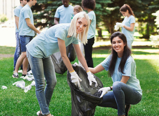 Volunteers collecting recyclable plastic bottles in park