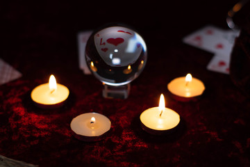 Magic crystal ball, cards and burning candles. Magic rites, the prediction of the future.