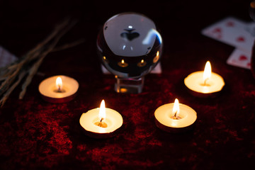 Magic crystal ball, cards and burning candles. Magic rites, the prediction of the future.