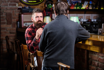 Friday relaxation in pub. Friends relaxing in pub. Friendly conversation with stranger. Hipster brutal bearded man spend leisure with friend bar counter in pub. Men relaxing in pub. Weekend leisure