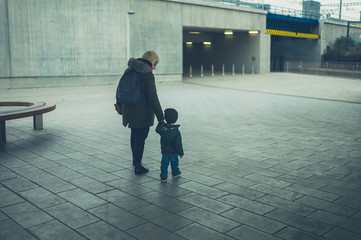 Toddler and grandmother walking in the city