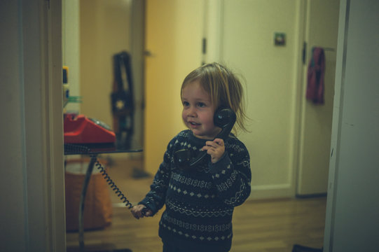 Little toddler talking on the phone