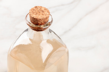A closeup photo of a corked bottle of a homemade face toner with copyspace