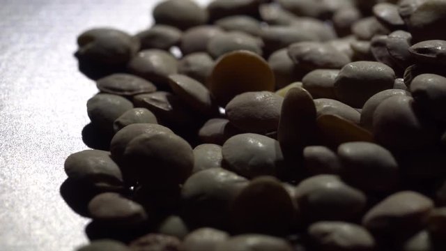 Lentils. Rotation. Close up. Heap of raw uncooked brown lentils in a bowl in rotation.  Food background. Studio shot. Healthy organic food diet concept