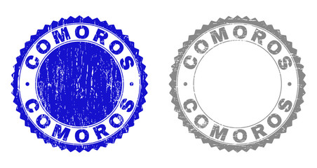 Grunge COMOROS stamp seals isolated on a white background. Rosette seals with grunge texture in blue and gray colors. Vector rubber stamp imitation of COMOROS label inside round rosette.