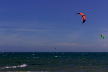 Kiteboarding, itesurfing at sunset in Mui Ne beach, Vietnam Phan Thiet