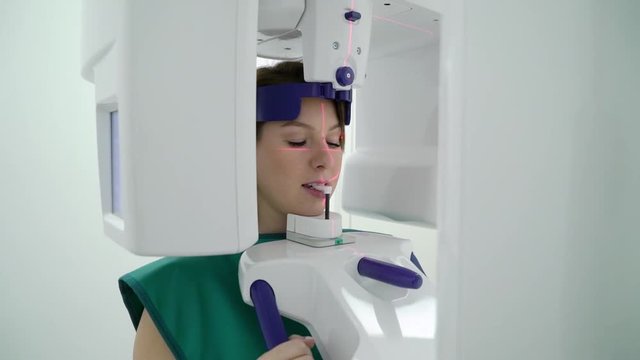 Woman patient in X-ray machine scanner in medical cabinet in hospital. Work place of doctor in clinic. Healthcare