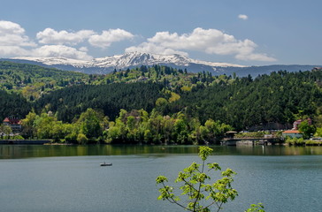 Look toward environment of springtime picturesque  dam,  resort village Pancharevo in Plana mountain and winter Vitosha mountain, Sofia, Bulgaria 