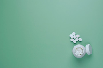 White pills with amberwhite bottle with blank label on the table with copy space for text. Vitamins...