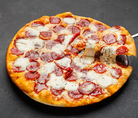 Hot pizza with melting cheese on table