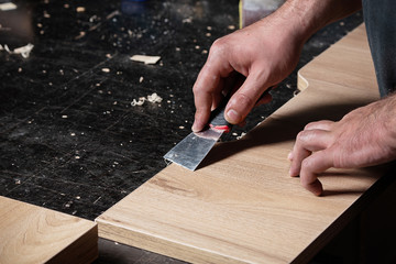 man rubs the surface with a spatula