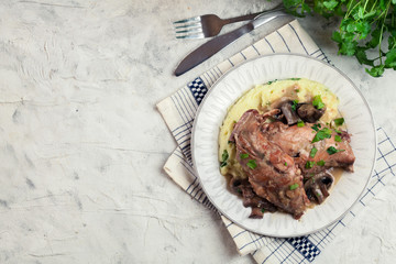 Stewed rabbit legs with vegetables