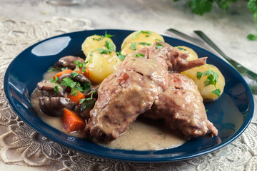 Stewed rabbit legs with vegetables