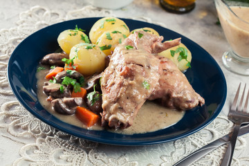 Stewed rabbit legs with vegetables
