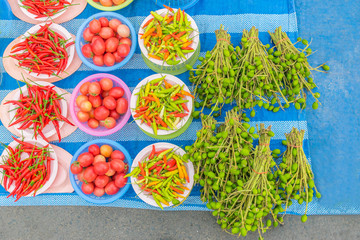 The ripe hot chili, mild fruit of mango. The inexpensive vegetable products for sale in the local market in Thailand.