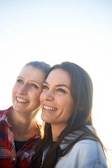 Portraits of a young lesbian couple enjoying their time together around a lake and jetty in winter sunshine