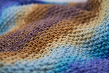 Blue and brown knitted textured background with blur on the edges