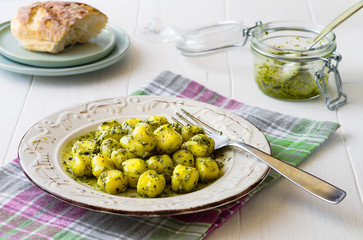 Portion of gnocchi with 'Pesto' sauce on wooden table