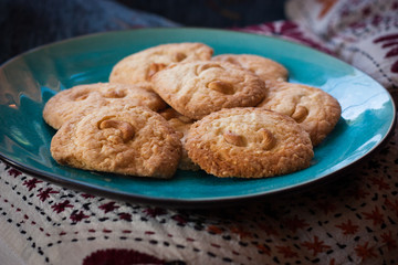 home-made cashew nut cookies, grandma's style on blue plate