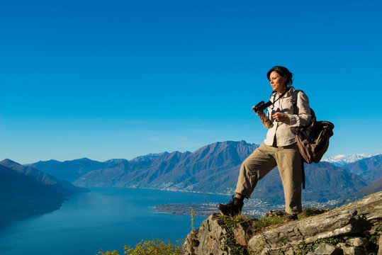 Woman Takes Pictures From Mountain Overlook in Ticino, Switzerland.