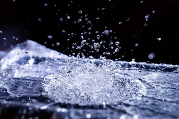 Water drops splashing on acoustic membrane. A lot of drops in air. High frequency of sound waves....