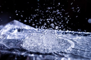Water drops splashing on acoustic membrane. A lot of drops in air. High frequency of sound waves....