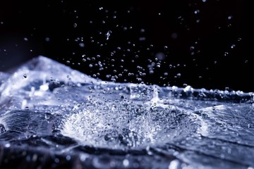 Water drops splashing on acoustic membrane. A lot of drops in air. High frequency of sound waves....