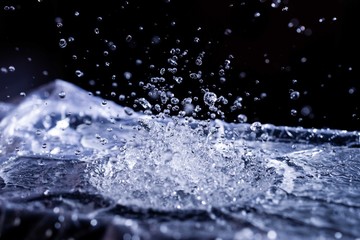 Water drops splashing on acoustic membrane. A lot of drops in air. High frequency of sound waves....