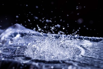 Water drops splashing on acoustic membrane. A lot of drops in air. High frequency of sound waves....