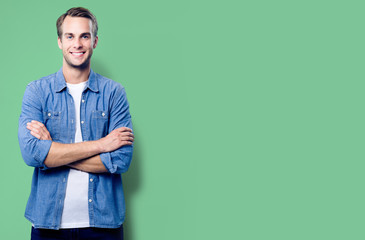 Portrait of young man standing in crossed arms pose