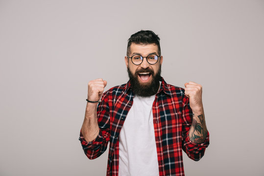 excited bearded man in checkered shirt, isolated on grey