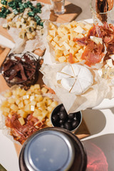 Top view of different kinds of cheese and meat on table ready for eating. Snacks for cocktail party. Vertical color photography.