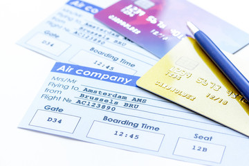 flight tickets payment online with cards on light wooden table