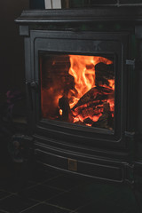 Cozy warm fireplace wooden stove close up interior burning fire