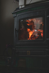 Cozy warm fireplace wooden stove close up interior burning fire