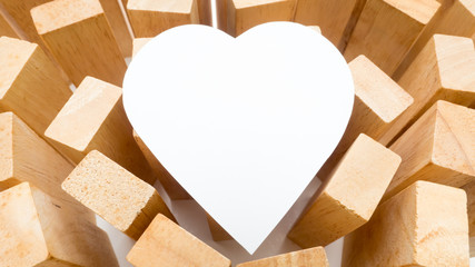 close up  white paper heart and wooden block
