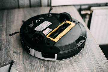 the back of the robot vacuum cleaner clogged with debris and dust
