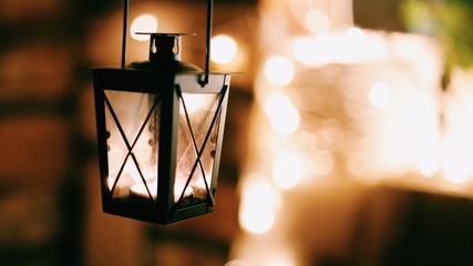 Fototapeta na wymiar Christmas dark lantern with candles. Background lights.