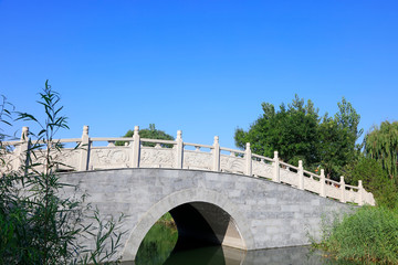 Archaize stone bridge in the park