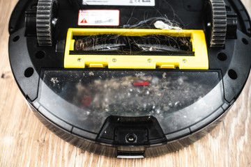 the back of the robot vacuum cleaner clogged with debris and dust