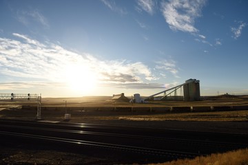 Industrial coal silo and train loading facilities in the Powder River Basin of Wyoming, USA.