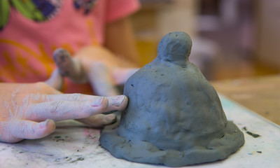 Make a doll of clay.