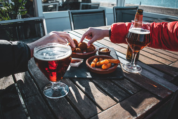 Enjoying beers and some snacks on spring afternoon at the beach 