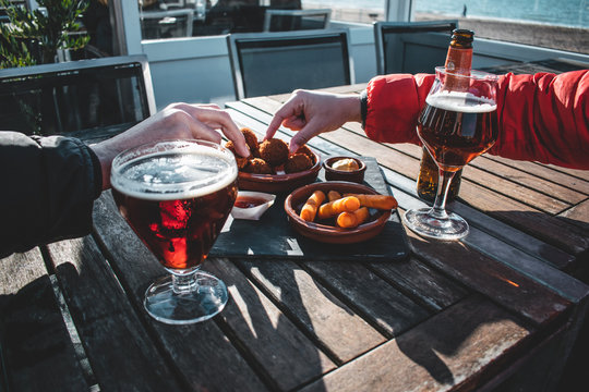 Enjoying Beers And Some Snacks On Spring Afternoon At The Beach 