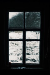 Worn window with a winter view. Old window in europe