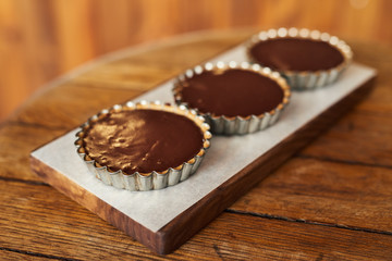 Delicious chocolate tarts sitting on a bakery table