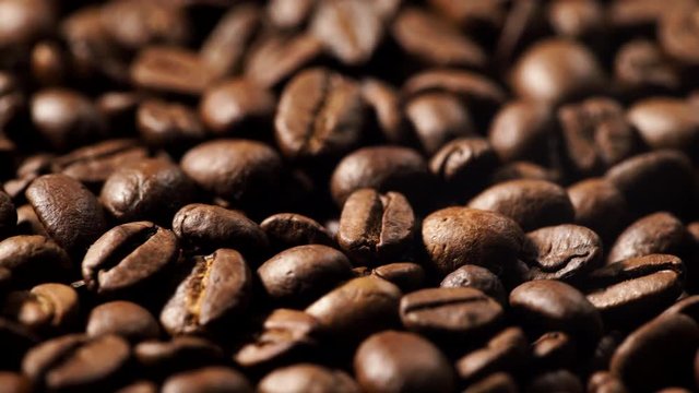 Close up of roasted brown coffee beans rotating