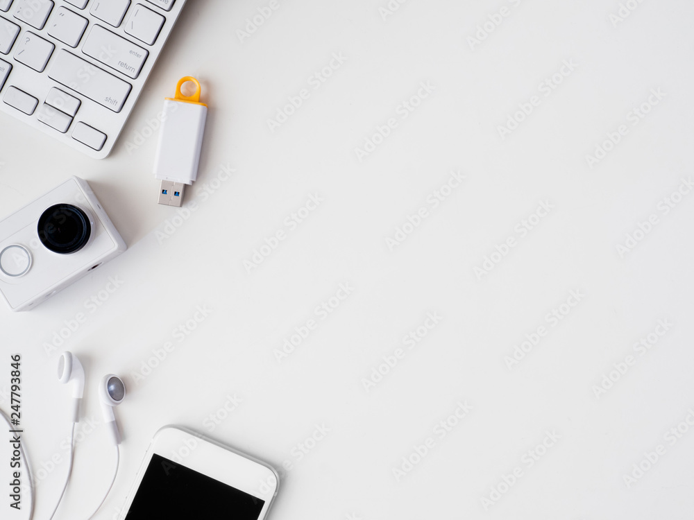 Poster top view of office desk work space with notebook, smartphone and gadget on white background with cop